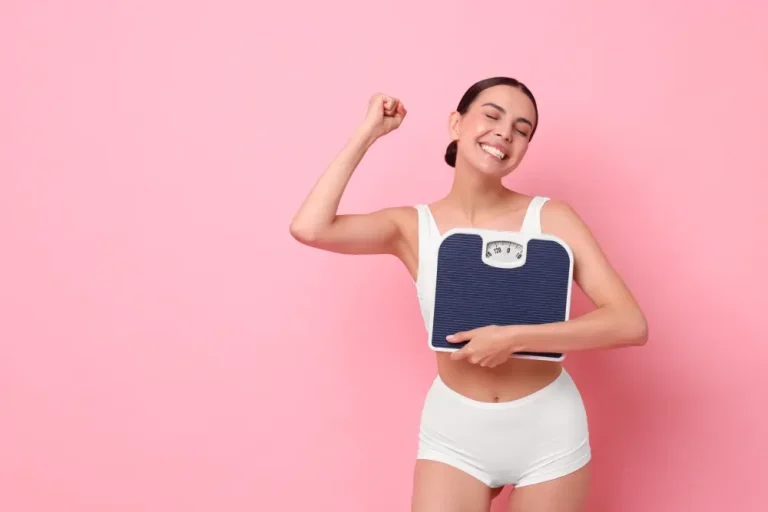 Happy woman holding a scale, celebrating weight loss success—exploring the transition from Semaglutide to Tirzepatide for weight loss.