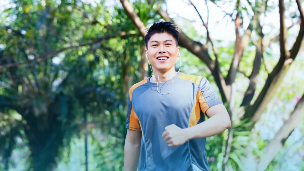 Man running outdoors in nature representing energy, vitality, and the effects of testosterone therapy