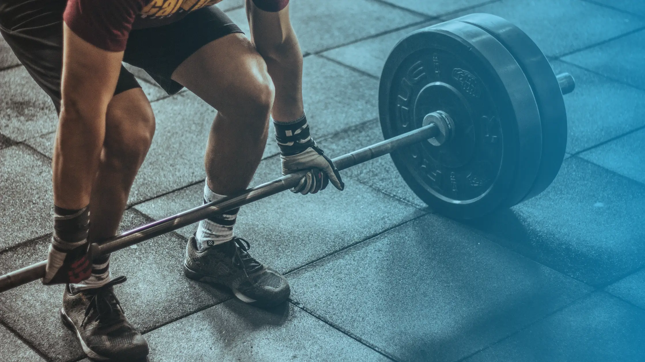 Athlete lifting heavy weights in the gym during a strength training workout to build muscle and improve performance
