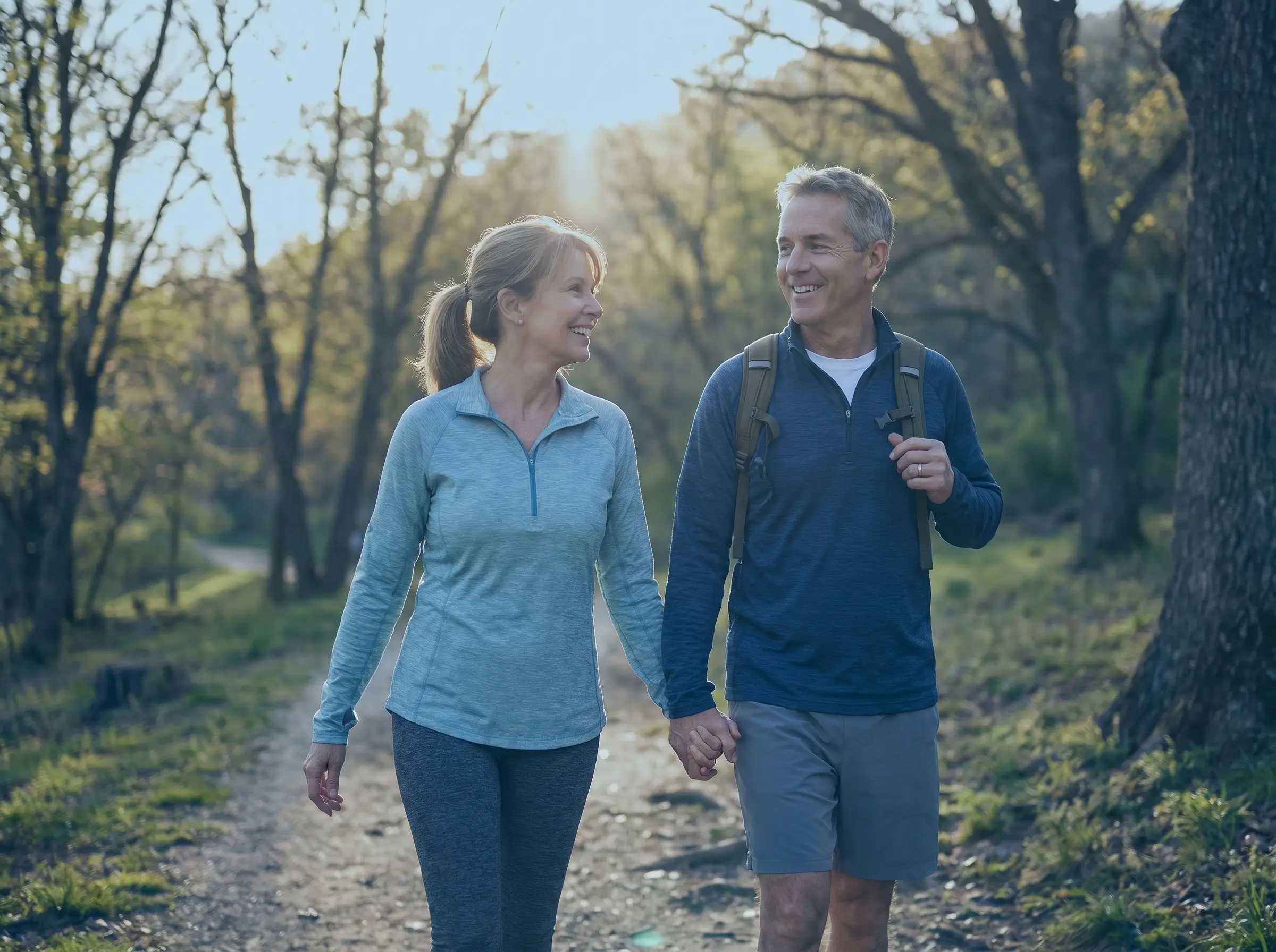 Happy middle-aged couple walking outdoors enjoying restored energy and vitality after hormone replacement therapy in the USA
