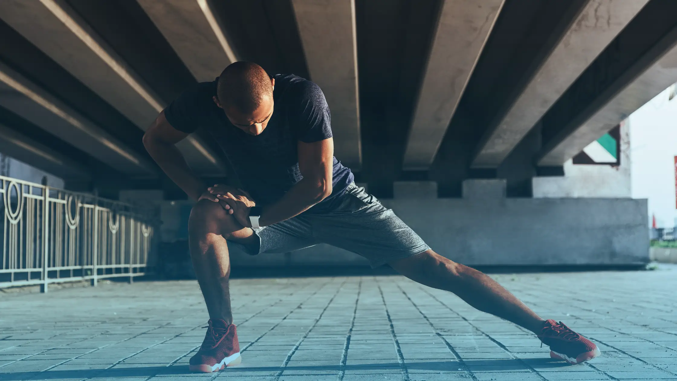Athletic man stretching outdoors representing muscle recovery and BPC-157 peptide therapy benefits