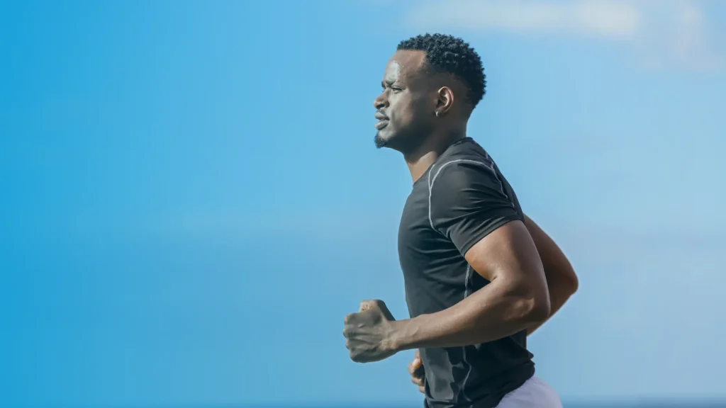 Athletic man running outdoors showing the energy, endurance, and muscle benefits of peptide therapy for men in the USA